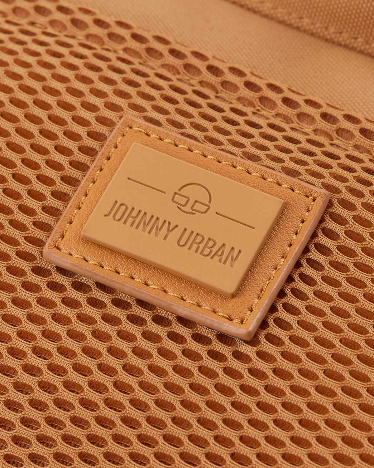 Nahaufnahme des braunen Johnny Urban Logos auf einem Netzstoff