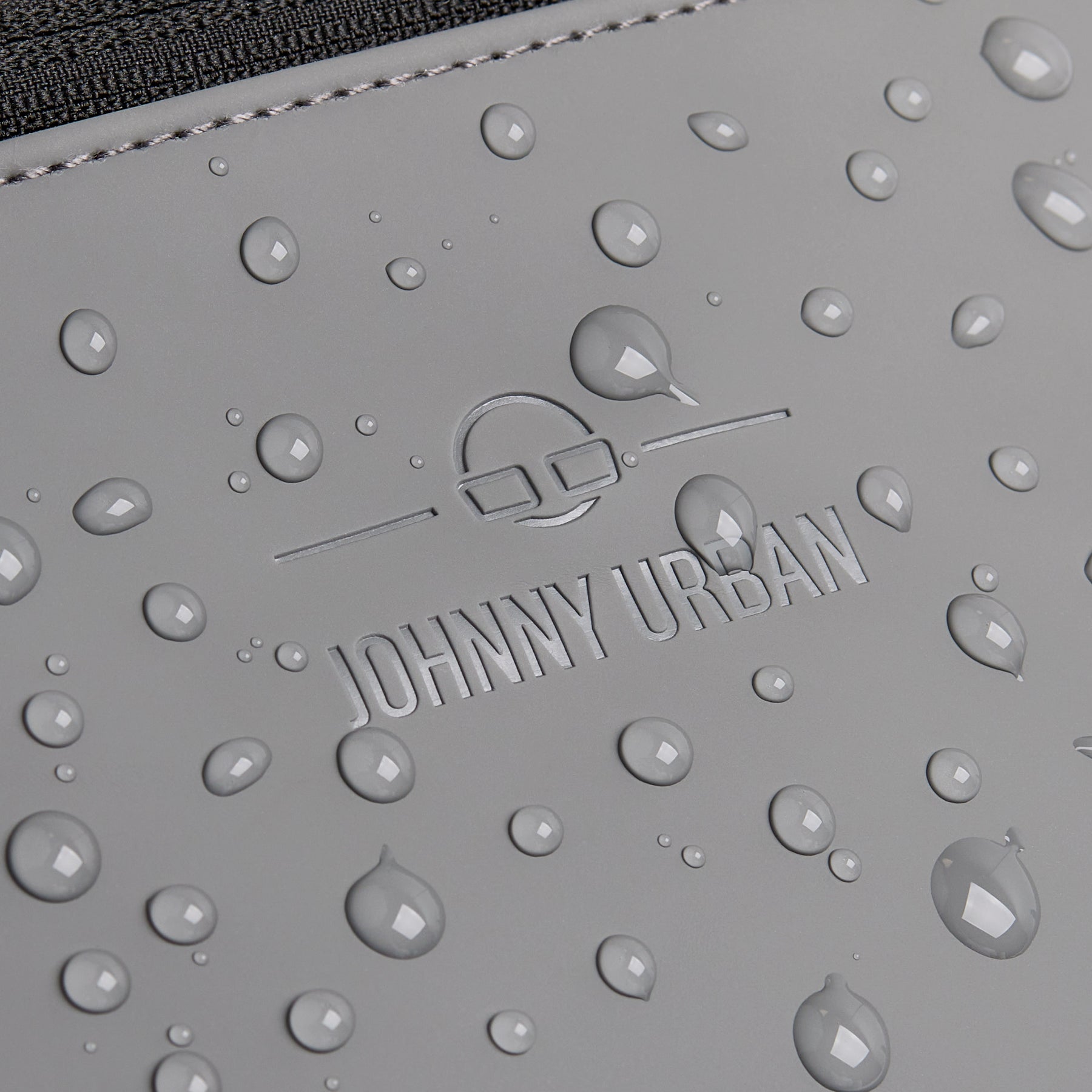 Wasserabweisende graue Oberfläche der Bauchtasche 'Riley' mit eingeprägtem Johnny Urban Logo